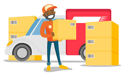 Image showing Young african delivery man carrying cardboard box.