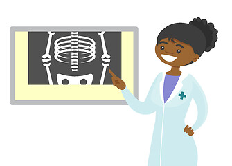 Image showing African radiologist doctor examining radiograph.