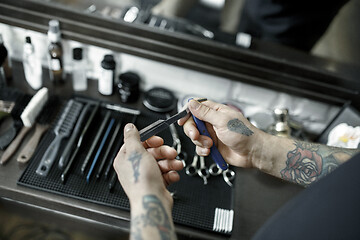 Image showing Tools for cutting beard barbershop top view. Vintage tools of barber shop on wooden background