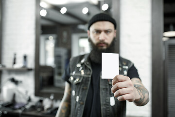 Image showing The male hairdresser against a barber shop