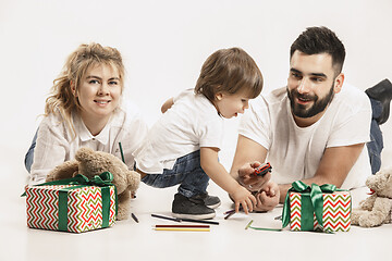 Image showing happy family with kid together and smiling at camera isolated on white