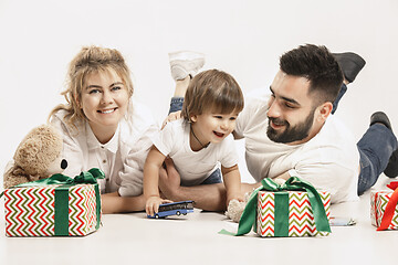 Image showing happy family with kid together and smiling at camera isolated on white