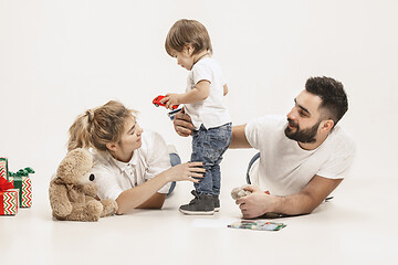 Image showing happy family with kid together and smiling at camera isolated on white