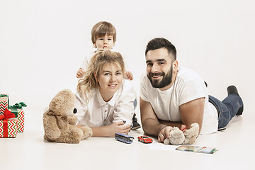 Image showing happy family with kid together and smiling at camera isolated on white