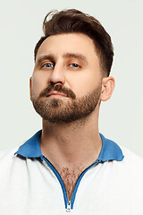 Image showing The serious man standing and looking at camera against white background.