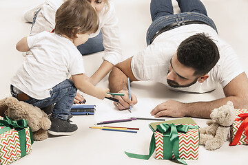 Image showing happy family with kid together and smiling at camera isolated on white