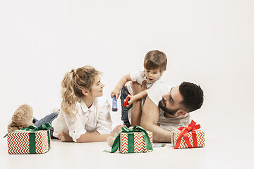 Image showing happy family with kid together and smiling at camera isolated on white