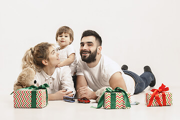 Image showing happy family with kid together and smiling at camera isolated on white