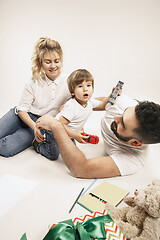 Image showing happy family with kid together and smiling at camera isolated on white