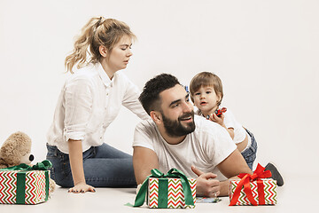 Image showing happy family with kid together and smiling at camera isolated on white