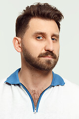 Image showing The serious man standing and looking at camera against white background.