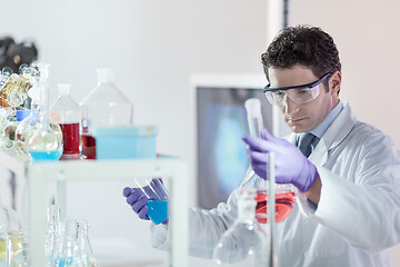 Image showing Researcher performing scientific experiment in chemical laboratory.