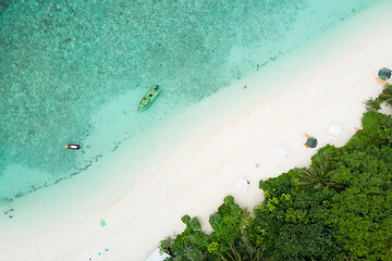 Image showing Aerial drone view of picture perfect beach and turquoise lagoon on small tropical island on Maldives