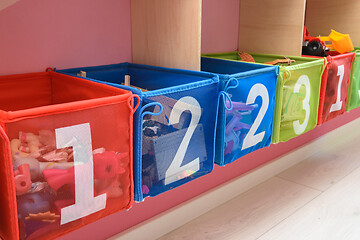 Image showing multi-colored boxes with numbers filled with little things