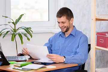 Image showing Office employee is happy to read paper documents