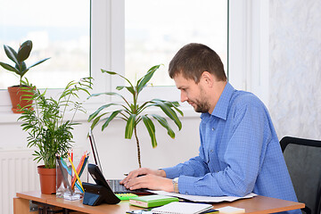 Image showing Office worker is typing on a laptop