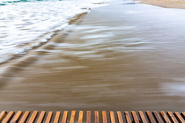 Image showing Sea surf rolling ashore after sunset, blurry with a long exposure