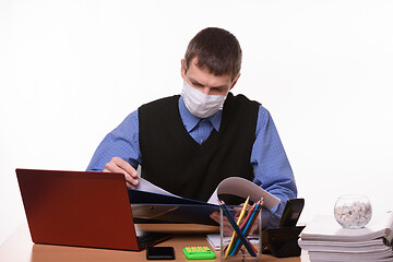 Image showing Office clerk leafing through documents in a folder