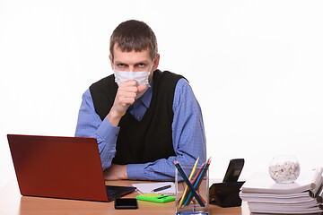 Image showing Office worker in a protective mask coughs in the office