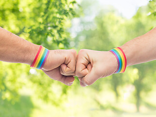 Image showing hands with gay pride wristbands make fist bump