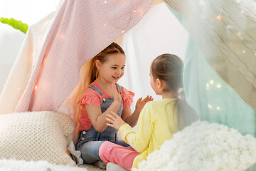 Image showing girls playing clapping game in kids tent at home