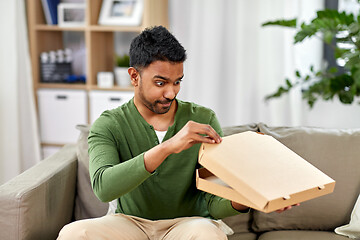 Image showing indian man looking inside of takeaway pizza box