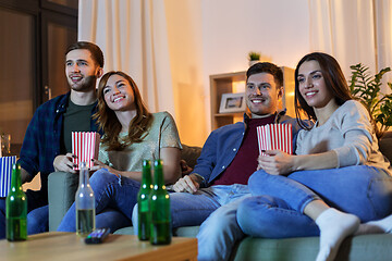 Image showing friends with beer and popcorn watching tv at home