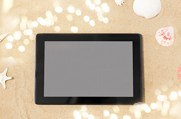 Image showing tablet computer and seashells on beach sand