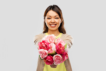 Image showing happy asian woman with bunch of flowers