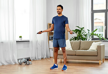 Image showing indian man exercising with jump rope at home