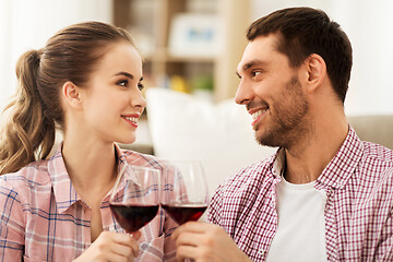 Image showing happy couple drinking red wine at home