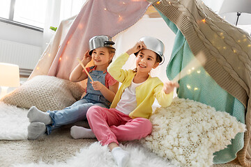 Image showing girls with pots playing in kids tent at home