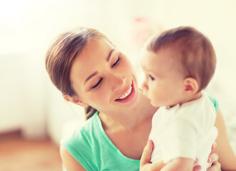 Image showing happy young mother with little baby at home