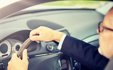 Image showing senior businessman hands driving car