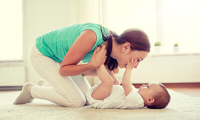 Image showing happy mother playing with baby at home