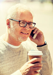 Image showing happy senior man calling on smartphone in city