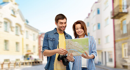 Image showing couple of tourists with map and camera in city