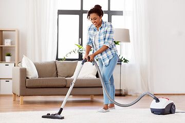 Image showing woman or housewife with vacuum cleaner at home