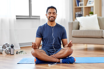 Image showing indian man meditating in lotus pose at home