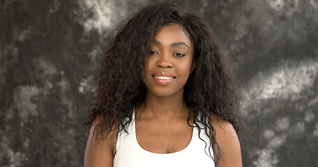 Image showing Positive black woman against gray wall