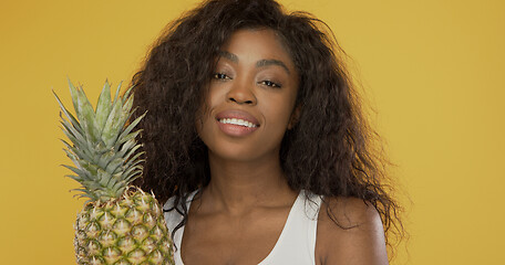 Image showing Positive African American woman with pineapple