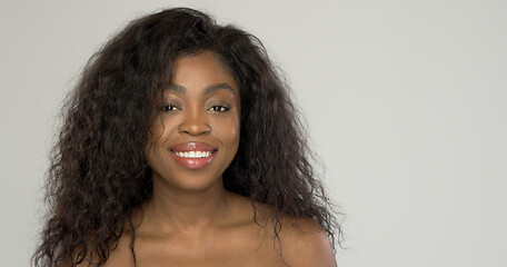 Image showing Cheerful black woman looking at camera