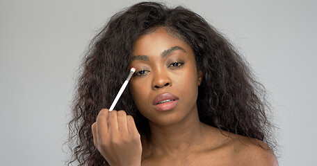 Image showing Attractive ethnic lady applying makeup