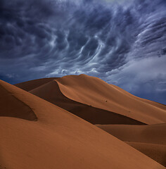 Image showing sand dunes and storm clouds in desert