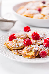 Image showing Poffertjes - small Dutch pancakes with fresh raspberries 