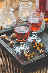 Image showing Two vintage glasses of red wine with bottle and lantern