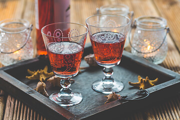 Image showing Two vintage glasses of red wine with bottle and lantern