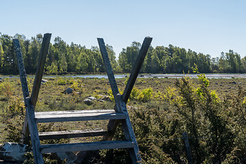 Image showing Wooden stile by a wetland for exploring the nature