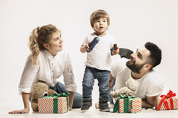 Image showing happy family with kid together and smiling at camera isolated on white