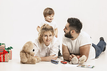 Image showing happy family with kid together and smiling at camera isolated on white